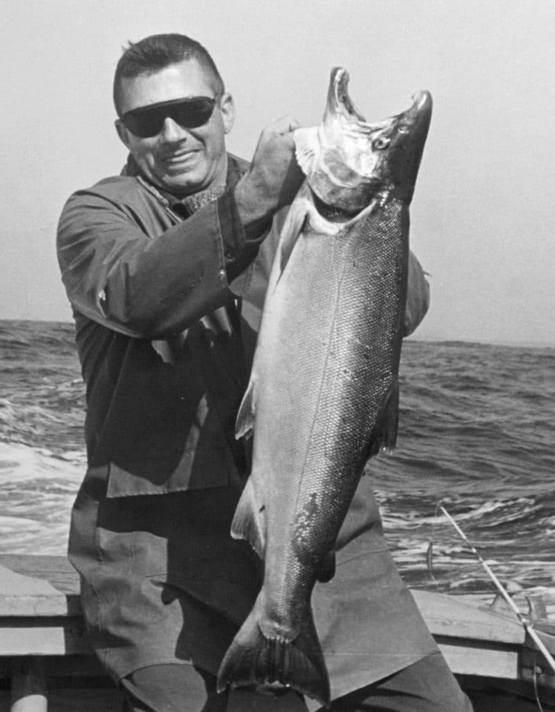 Howard Tanner holding up a salmon