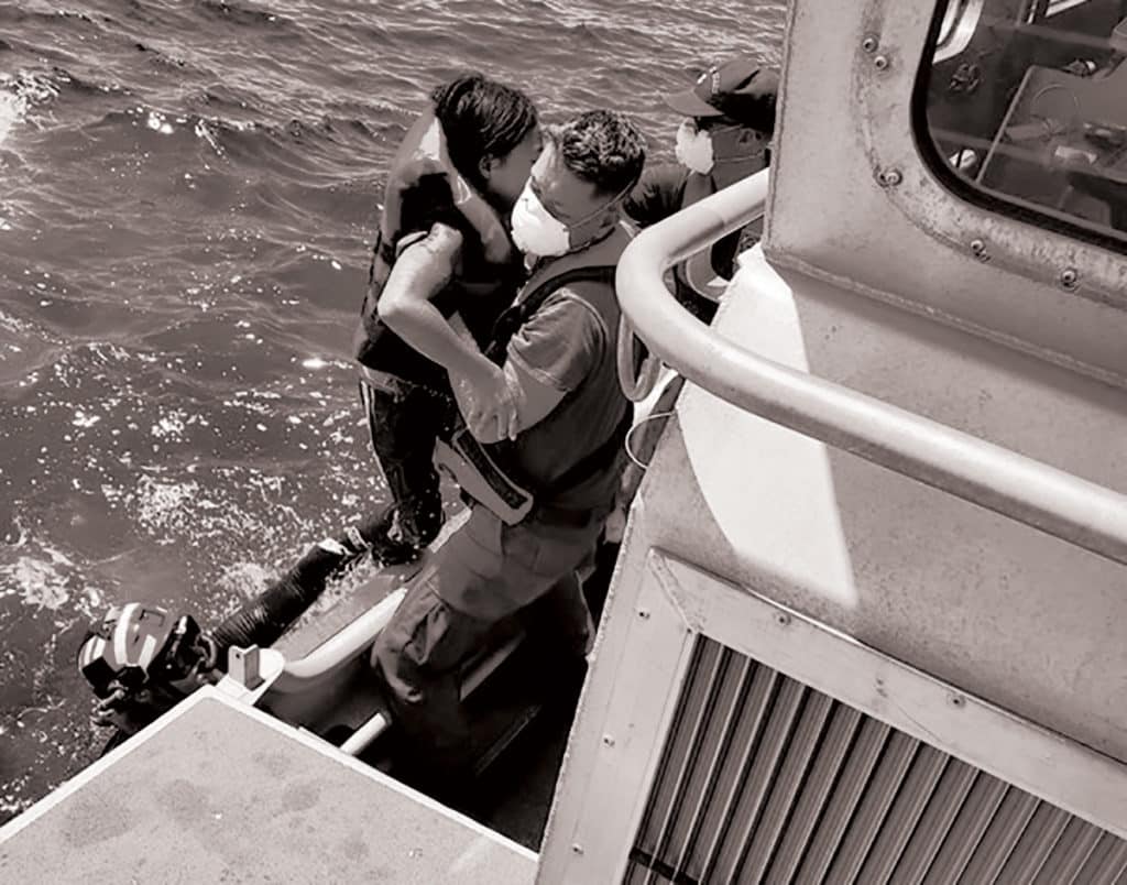 Boater being rescued by the Coast Guard