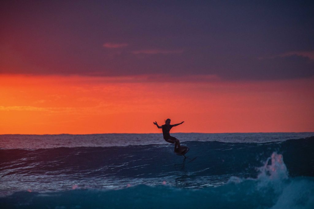 Surfer e-foiling in the lineup