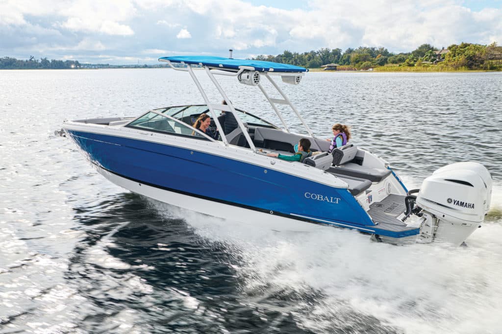 Cobalt R8 Outboard running near shore with a family on board