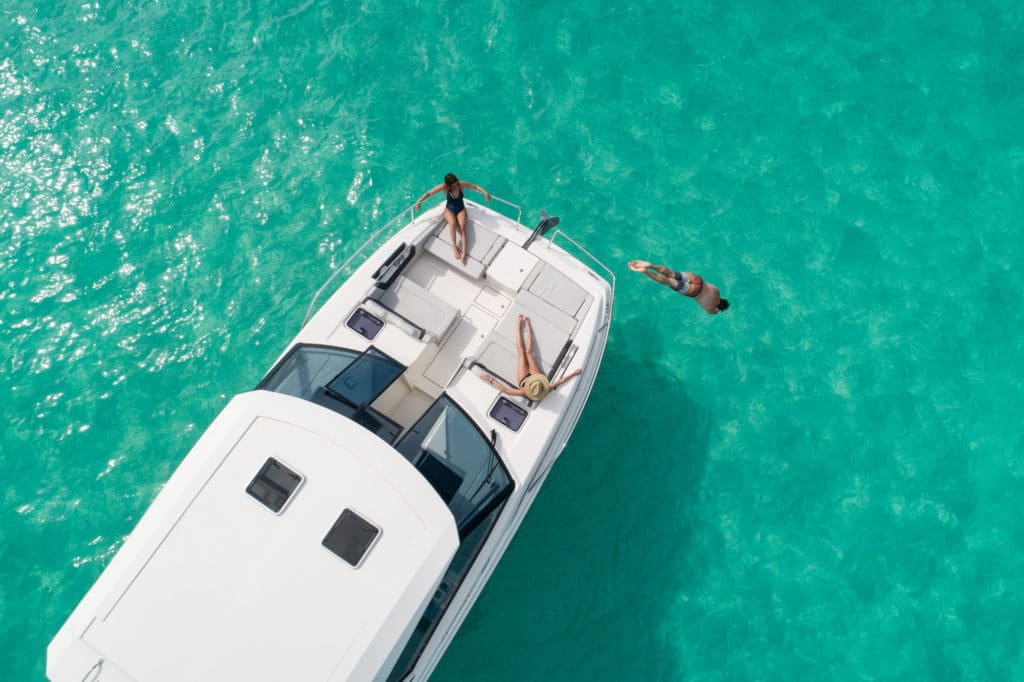 People swimming off of a charter boat