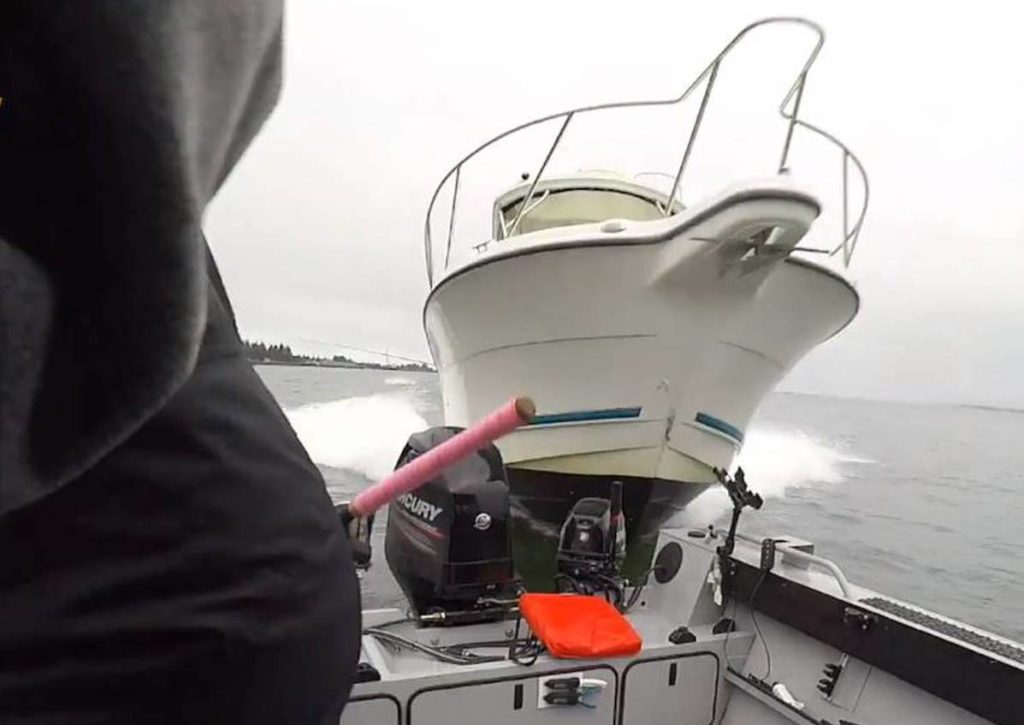 Large boat bearing down on fishermen