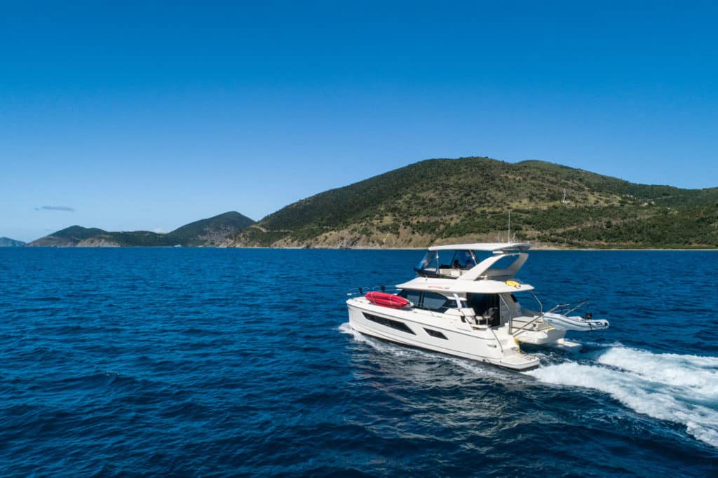 Catamaran sailing near an island