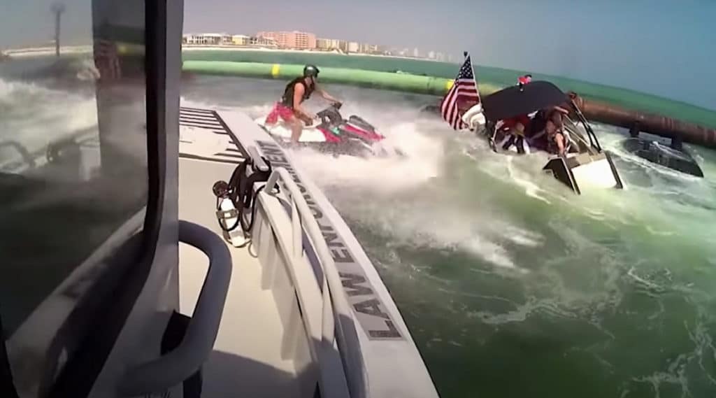 Marine patrol office using a PWC to rescue boaters