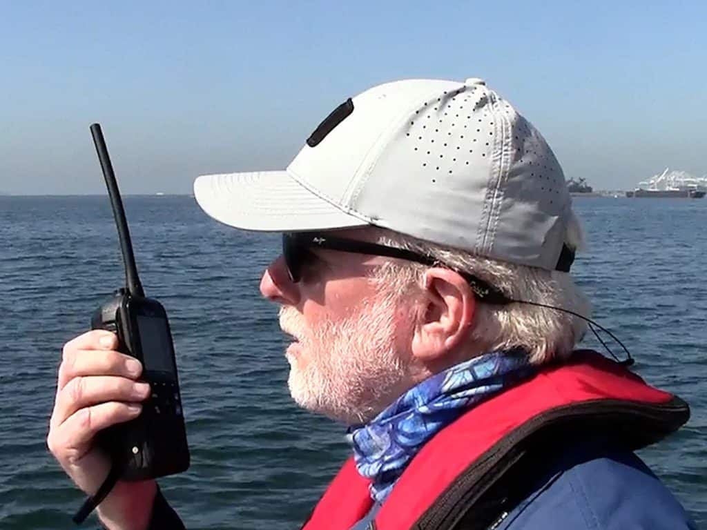 A man talking into a two way radio