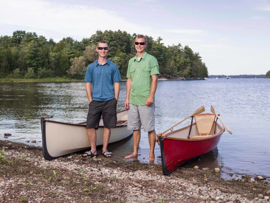 Justin and Ian Martin standing next to their boats.