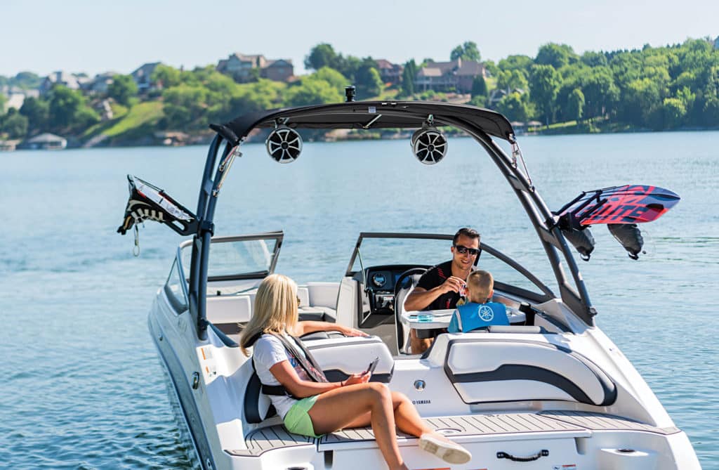 The cockpit features a bench seat wrapping from the stern all the way to the port console.