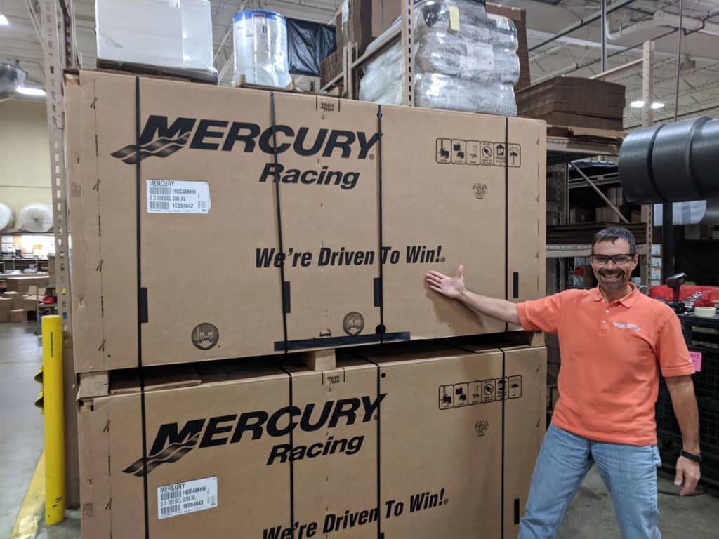 Rick Mackie In Front of Mercury Racing Crates