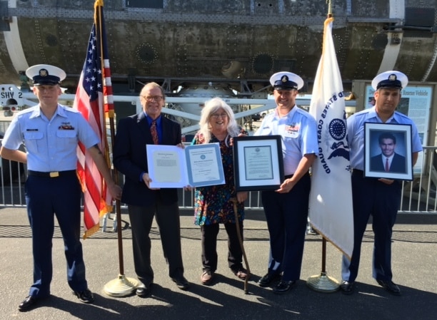 Marion Irving deCruz accepts award from US Coast Guard