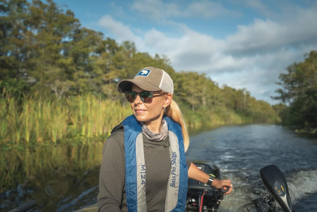 Woman boating with an inflatable life jacket on