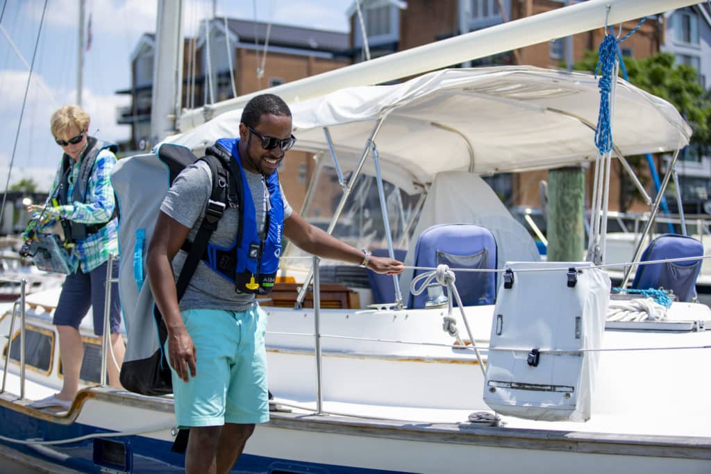 Boaters safely walking off a boat