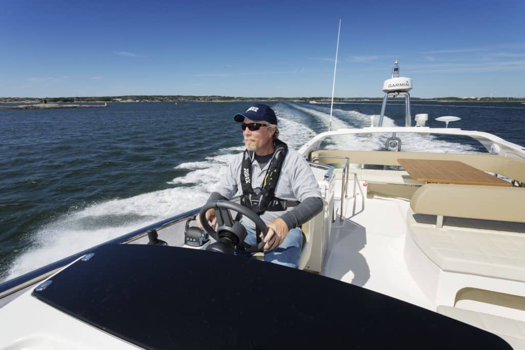 Editor-In-Chief, Kevin Falvey, powers a Cranchi 48 towards the North Sea from the mouth of Sweden's Gota Alv River while sea trilaing new new Volvo Penta engine