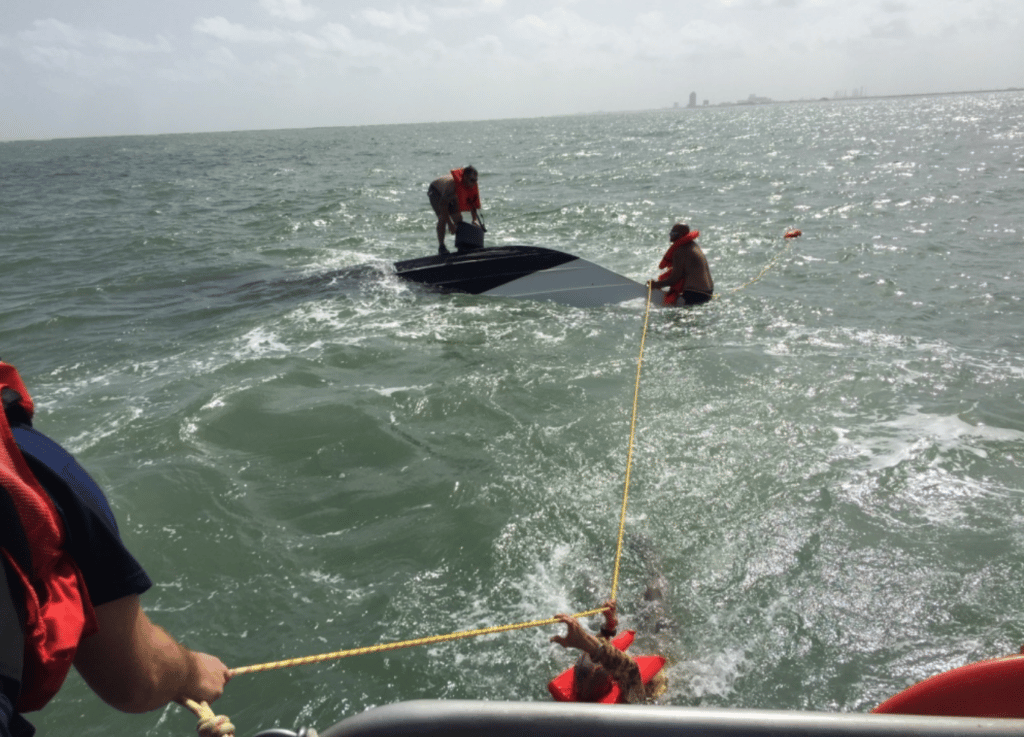 USCG saves three men from sinking boat.