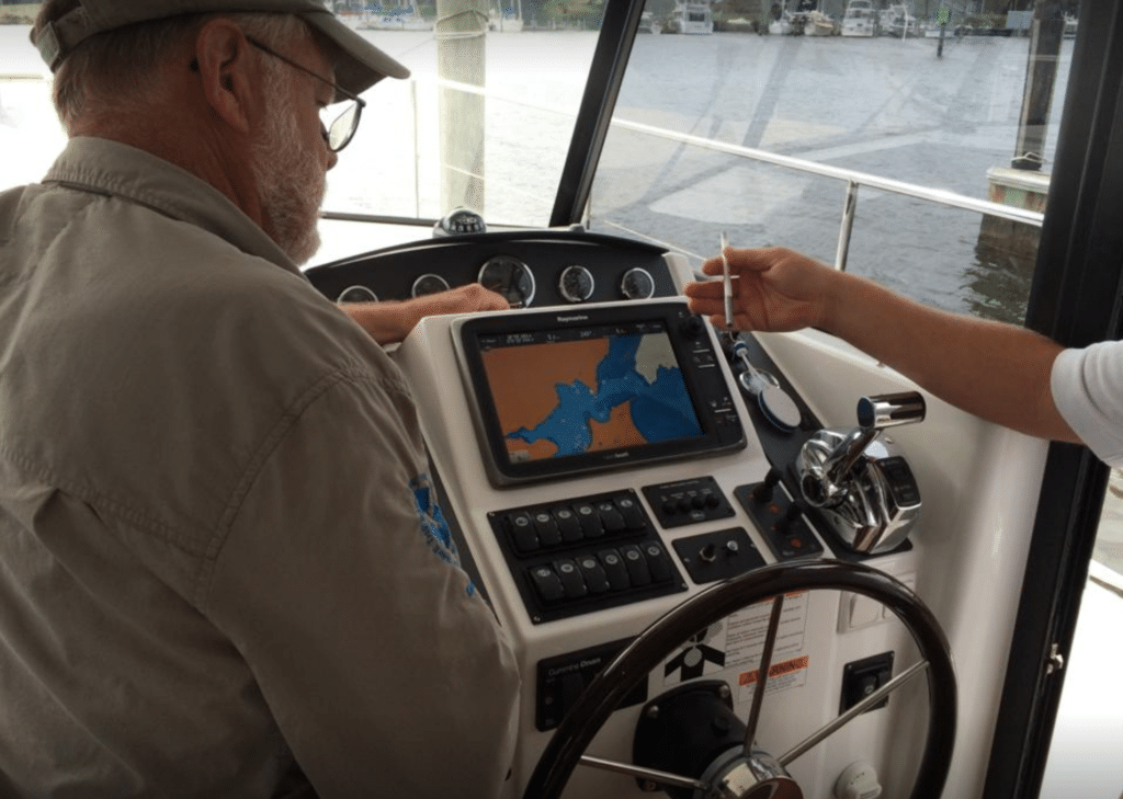 Capt. John Page Williams at the helm of the Beneteau