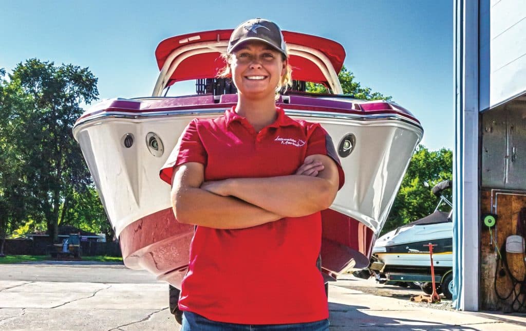 Kaitlyn Schneider in front of a boat