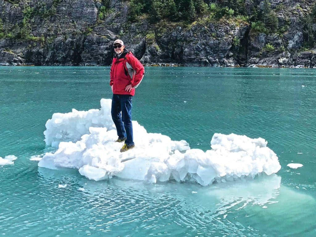 Charles Plueddeman standing on iceberg