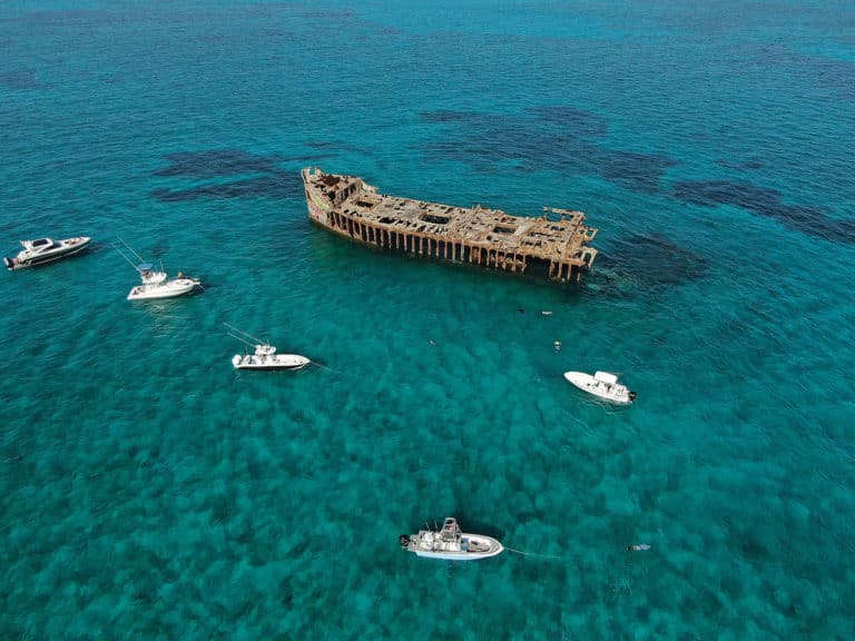 Boats near abandoned ship in the Bahamas