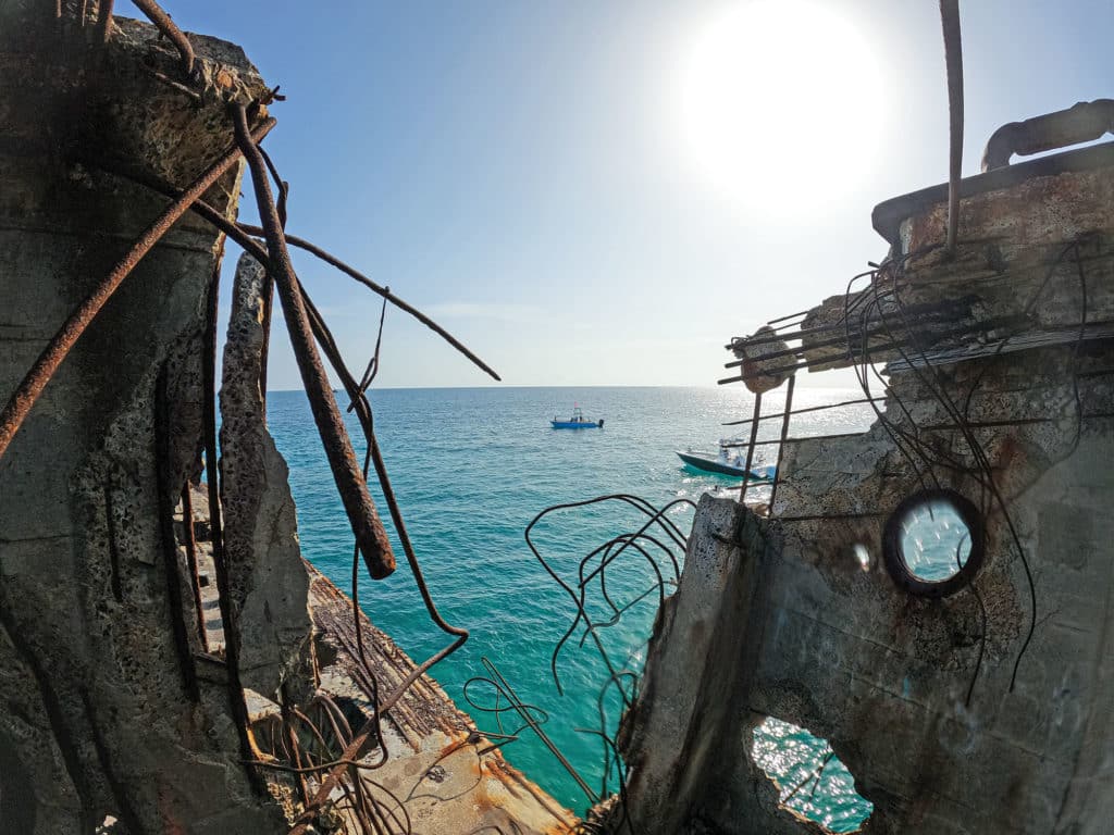 Boat near abandoned ship