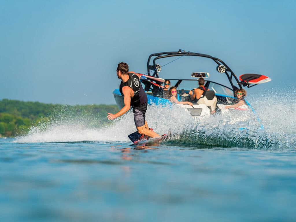 Wakeboarder behind a family boat