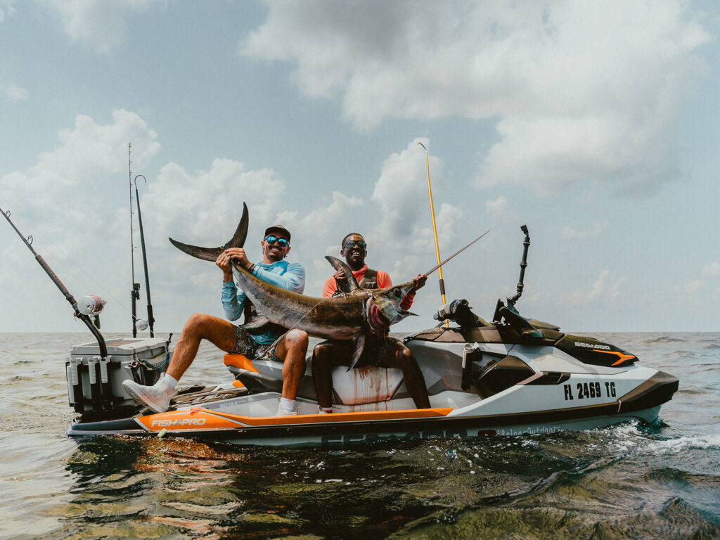 Emmanuel Williams and Sebastian Noel with swordfish on a PWC