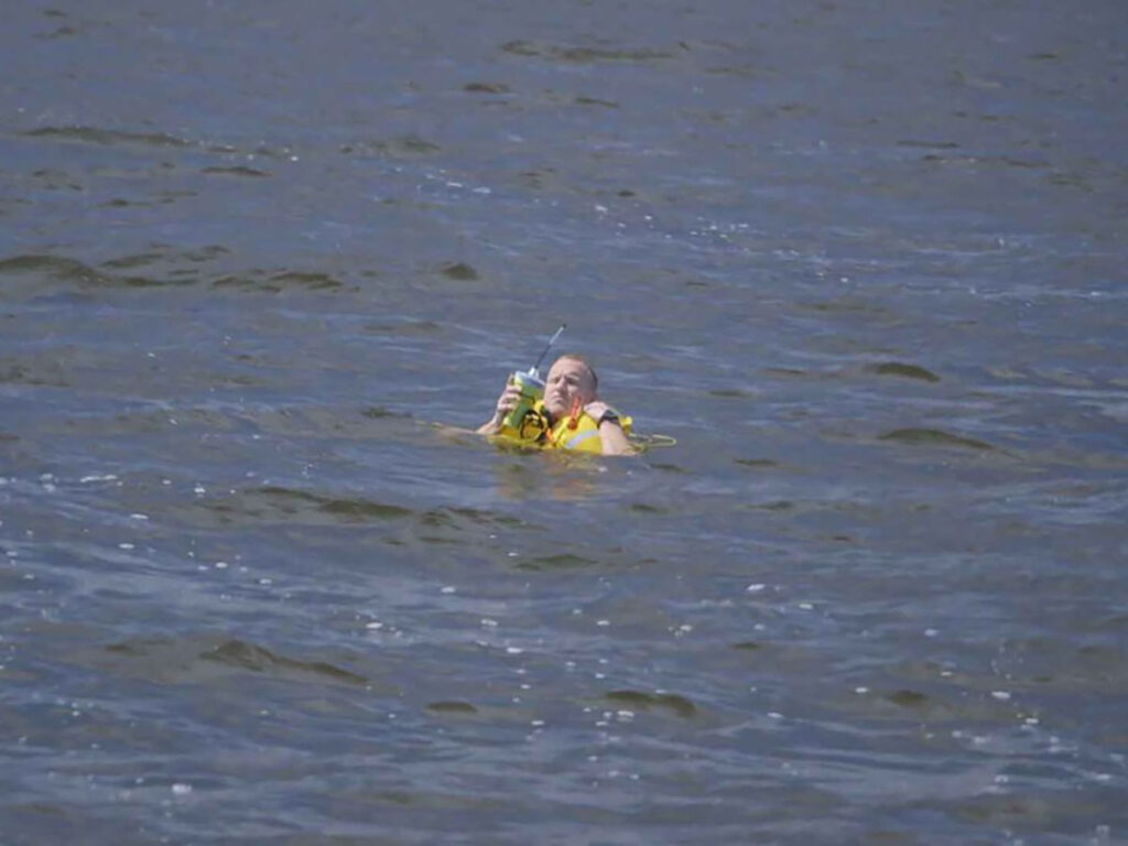 Boater in the water with life jacket on