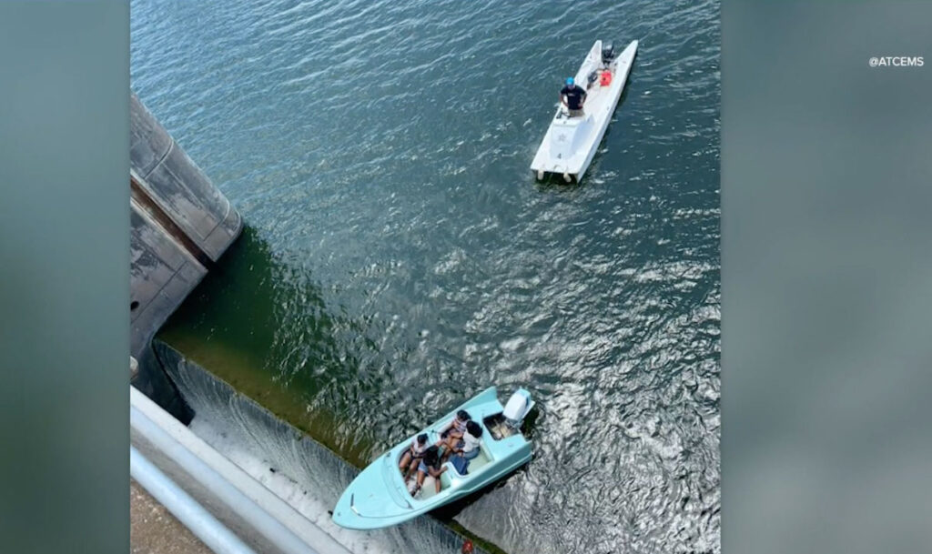 Boat teetering on a dam