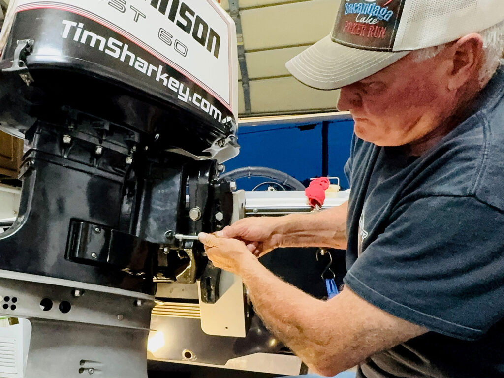 Tim Sharkey installing Johnson outboard