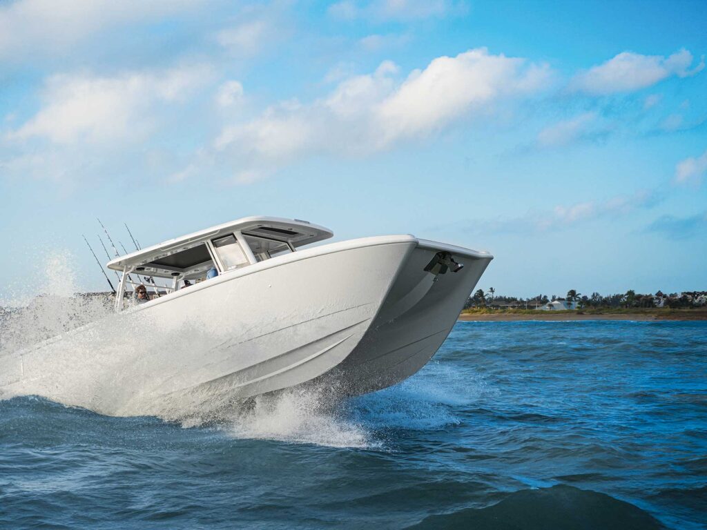 Twin Vee 400 GFX2 cresting over waves